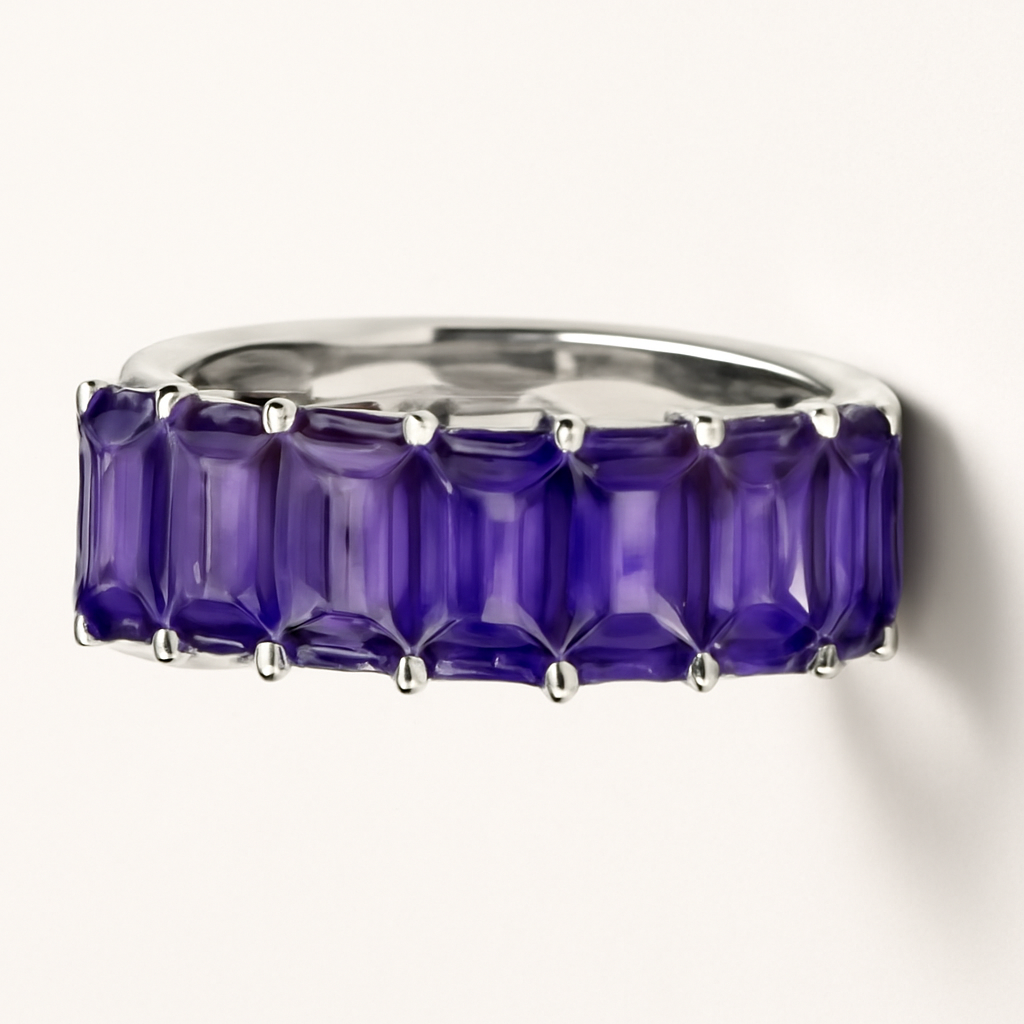 Silver band ring with prong-set purple baguette stones.