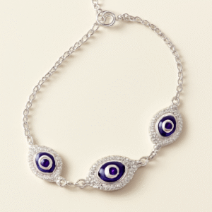 Silver chain bracelet with three blue evil eye motifs surrounded by American Diamonds.
