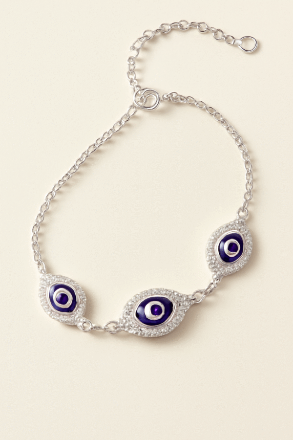 Silver chain bracelet with three blue evil eye motifs surrounded by American Diamonds.