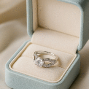 silver solitaire ring featuring a large central stone with an infinity-shaped zircon-studded band, displayed in a soft blue velvet ring box.