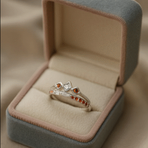 Silver Crown Ring with a combination of red-orange and pink gemstones, placed in a soft velvet jewelry box — capturing elegance and feminine royalty.