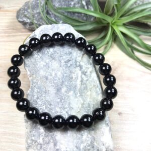AdiShakti bracelet with natural Black Tourmaline crystal beads, designed for unisex spiritual wear, offering protection and grounding energy.