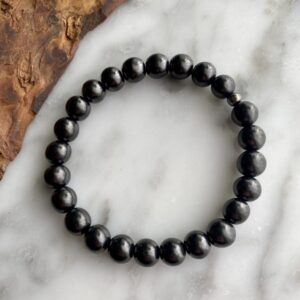 AdiShakti Shungite Bracelet featuring polished black natural stones, designed for unisex energy protection, EMF shielding, grounding, and detox support.