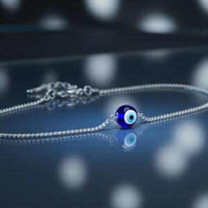 Minimalist 925 silver bracelet with a blue evil eye charm centerpiece, displayed on a reflective dark background for an elegant and spiritual look.